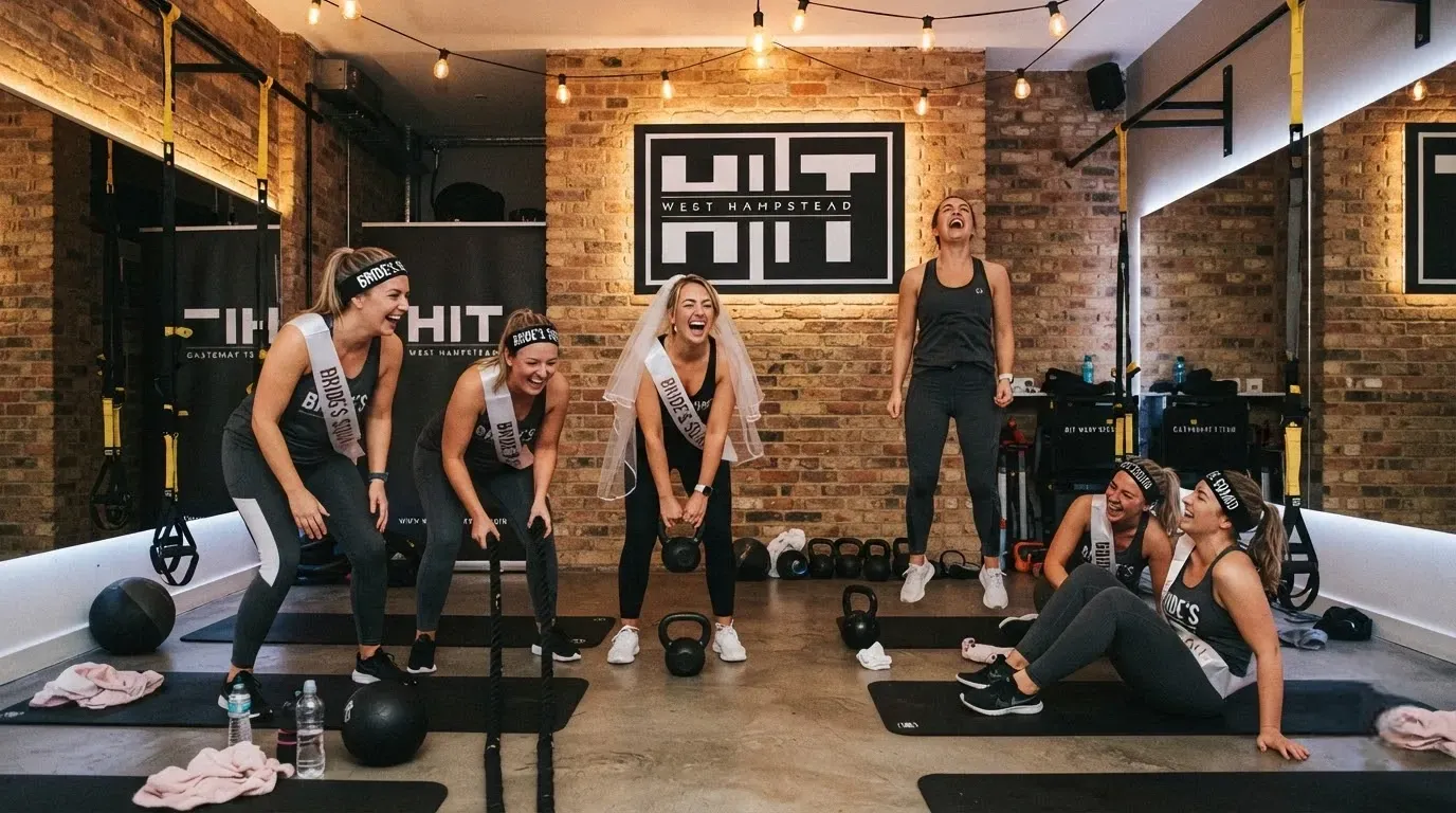 Group of hen party guests laughing together during a private hen fitness class