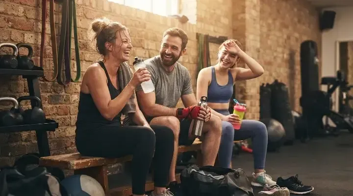 Members smiling after a workout, showing the stress relief benefits of boxing vs HIIT