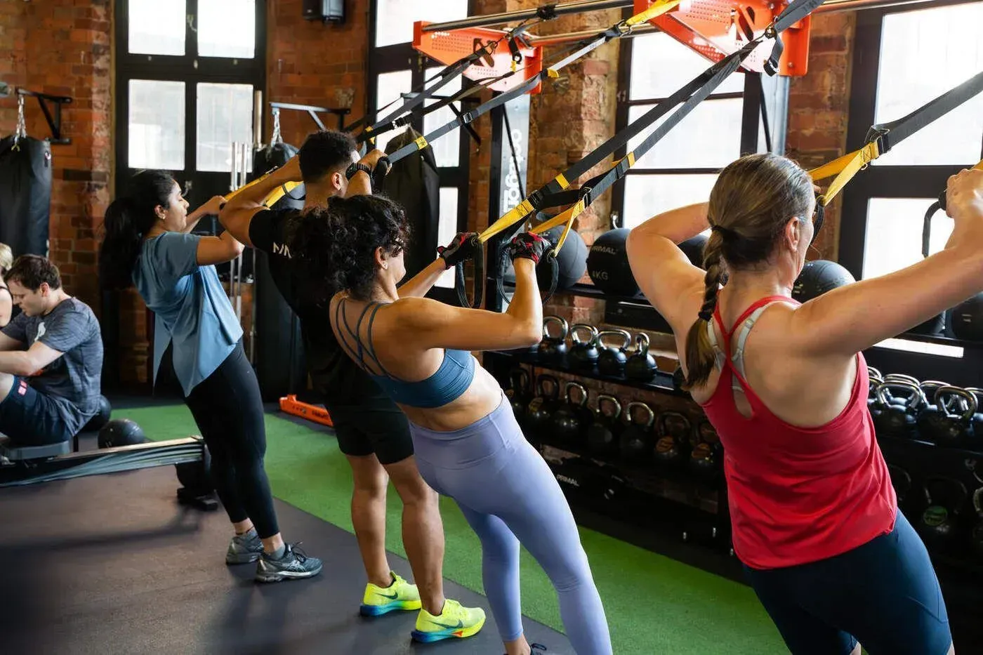 HIIT West Hampstead members training with suspension straps in the gym