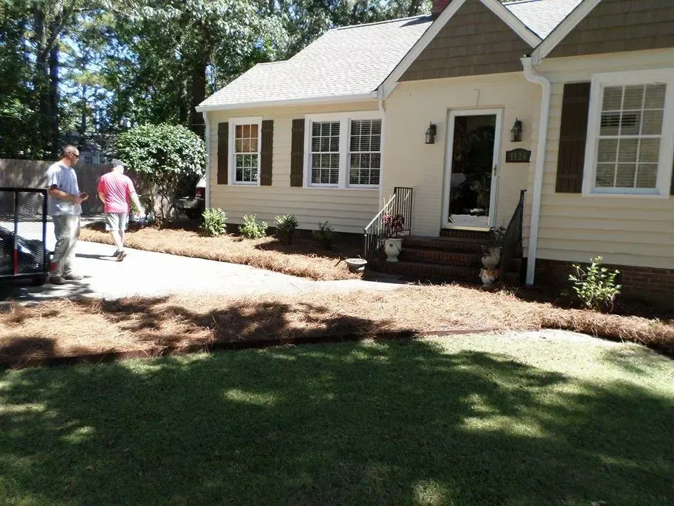 Honey Badger Lawn & Landscape
- A couple of men standing in front of a house