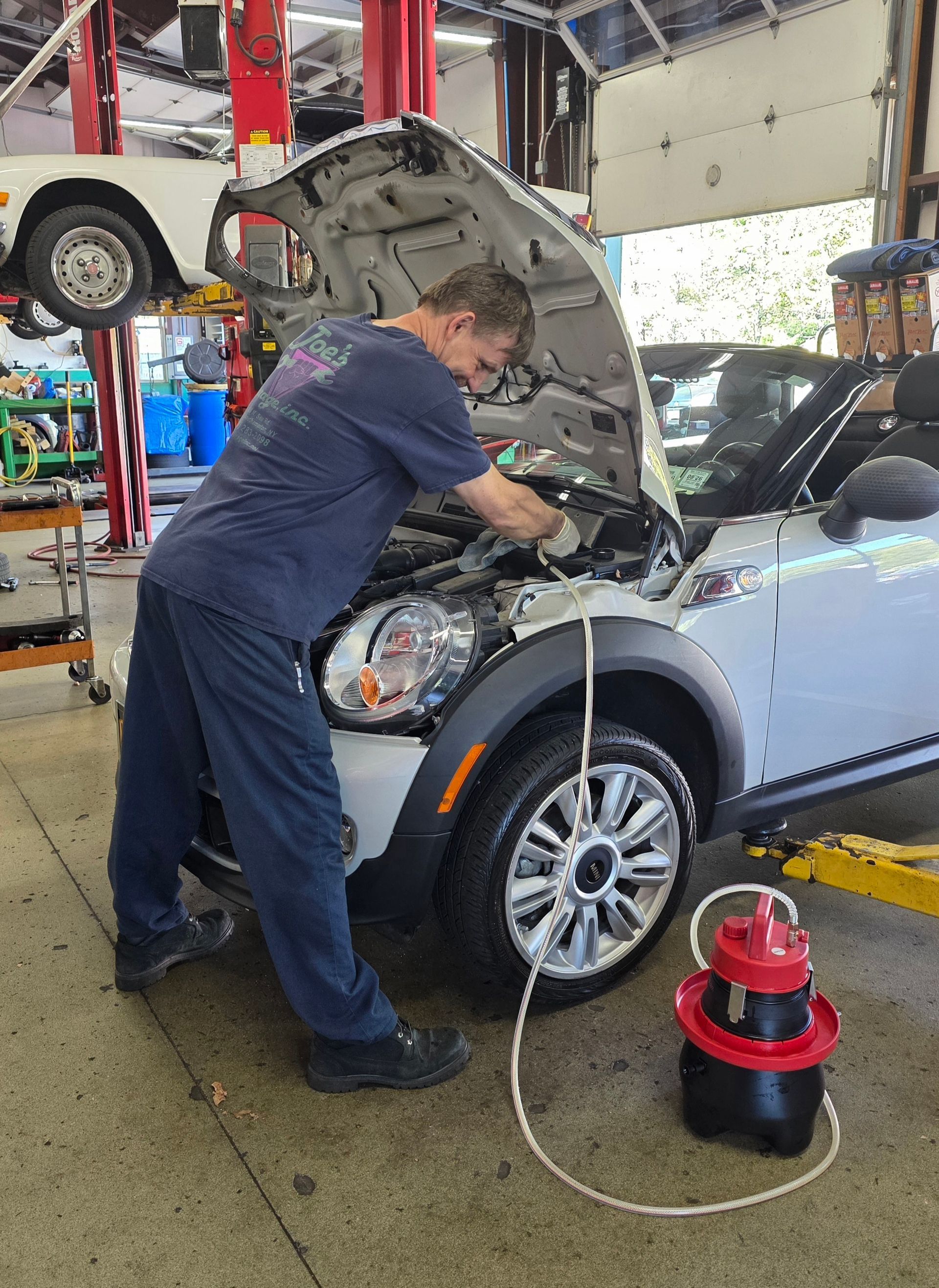 Shop's Auto Technician Working | Joe's Garage Inc.