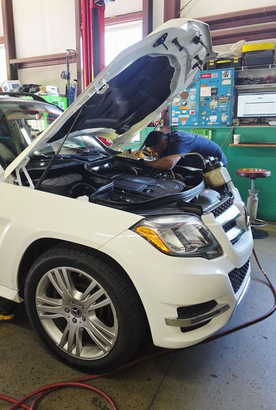 Technician Working on a Large Car Engine | Joe’s Garage Inc.