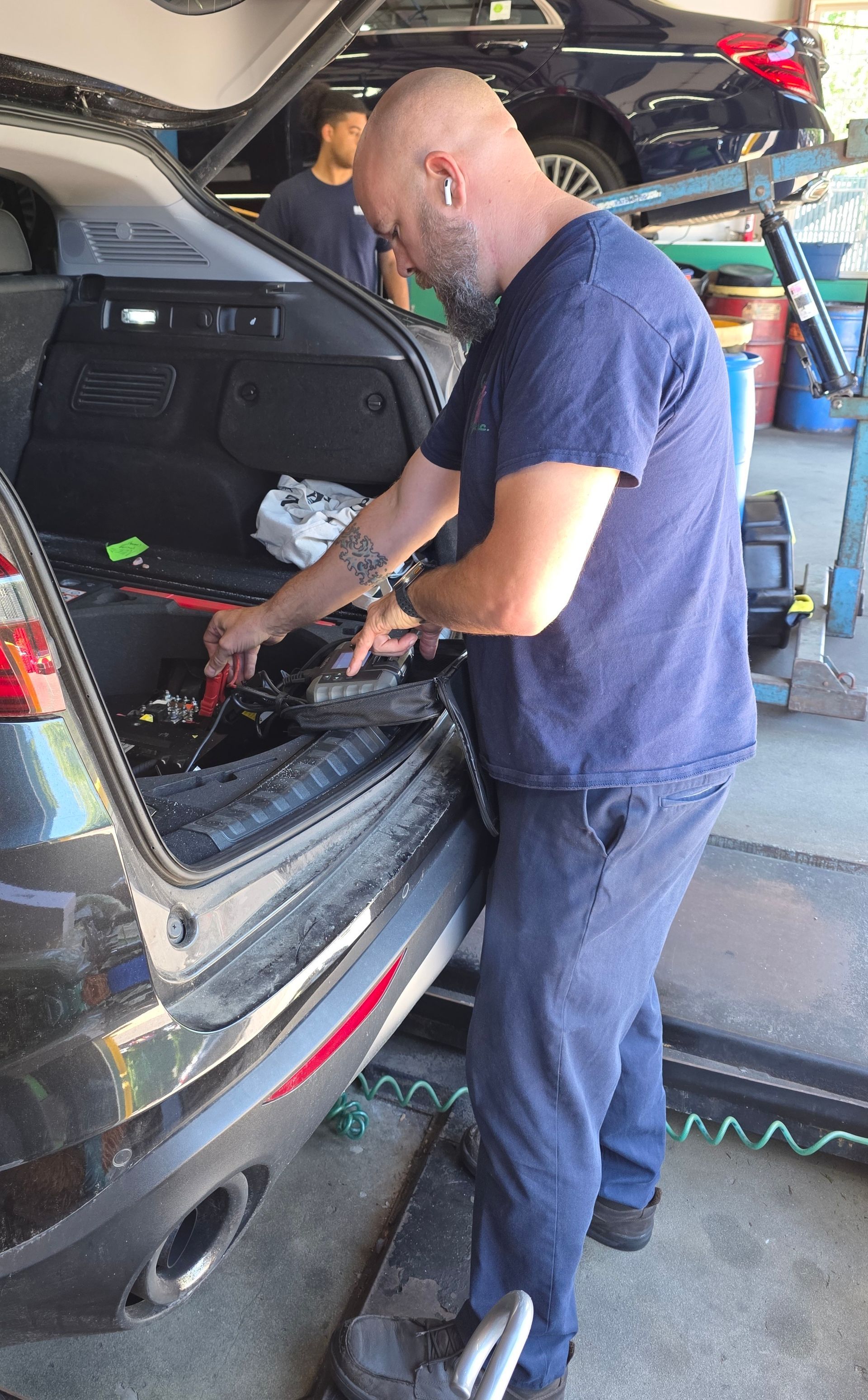Man, Potentially an Engine Builder or Mechanic, in a Garage Setting with a Custom Air-Cooled Engine | Joe’s Garage Inc.
