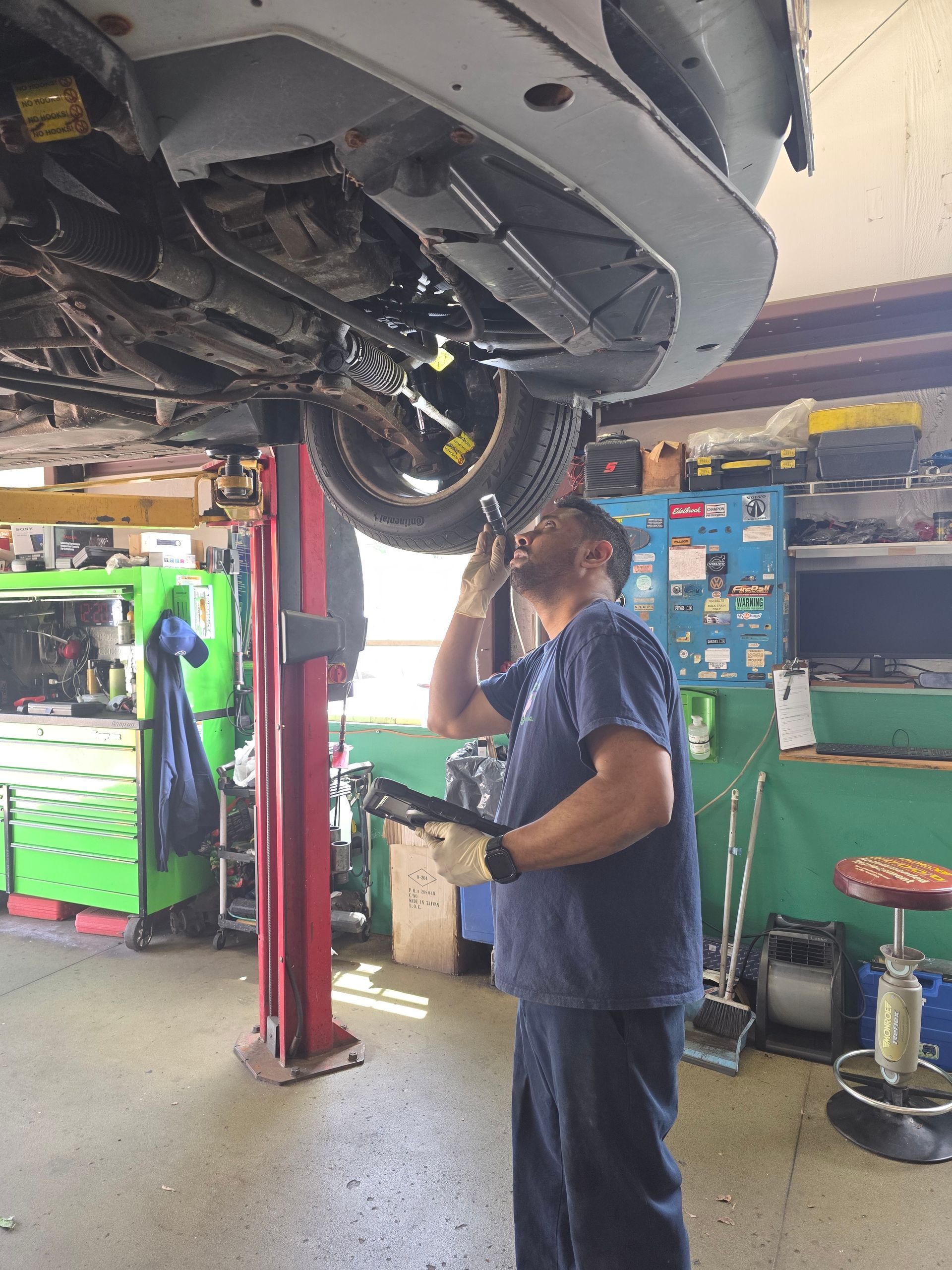 Shop's Auto Technician Working | Joe's Garage Inc.