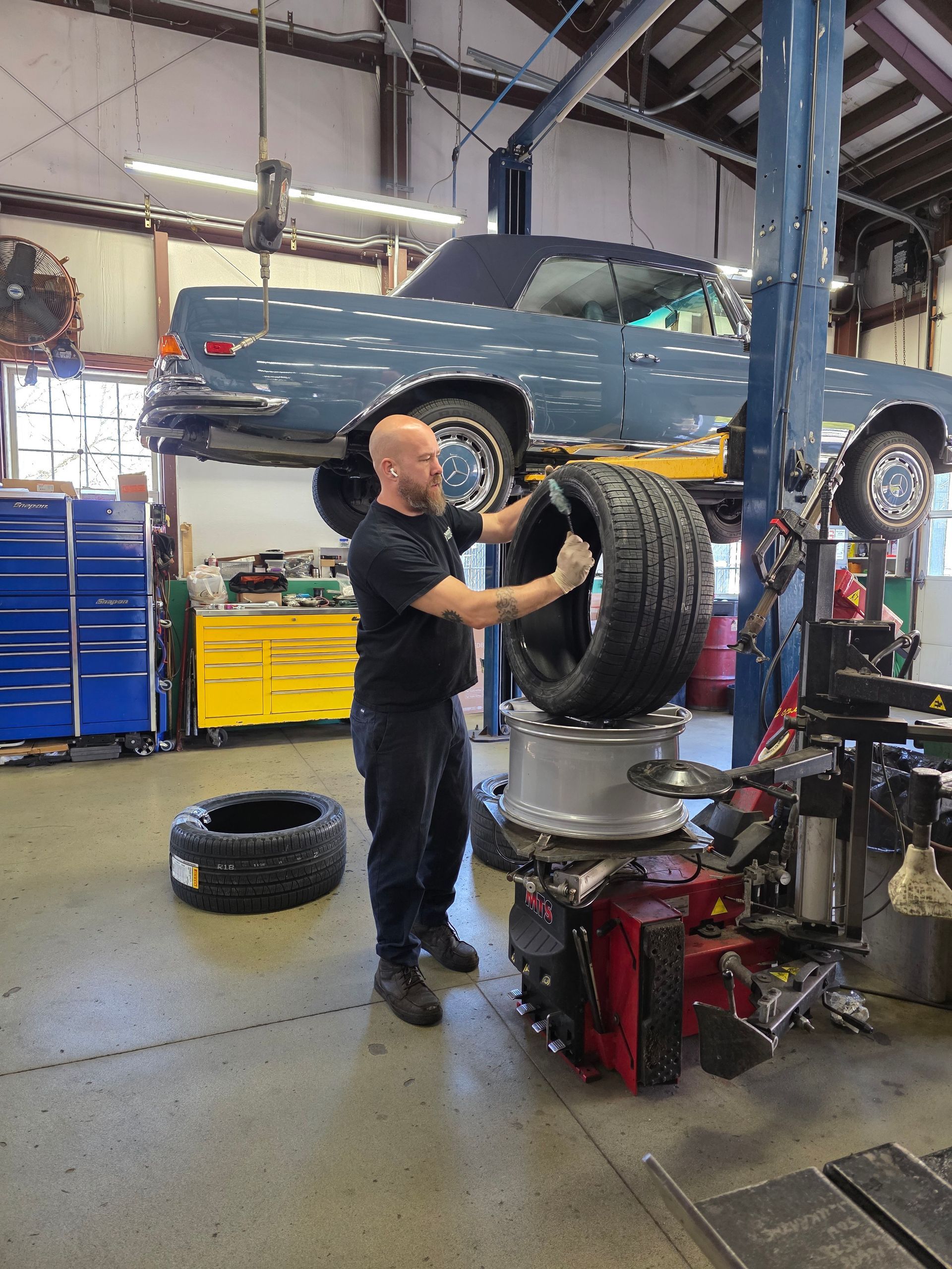 Shop's Auto Technician Working on Tires | Joe's Garage Inc.