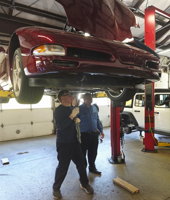 Mechanics Working on a Vehicle Engine | Joe’s Garage Inc.