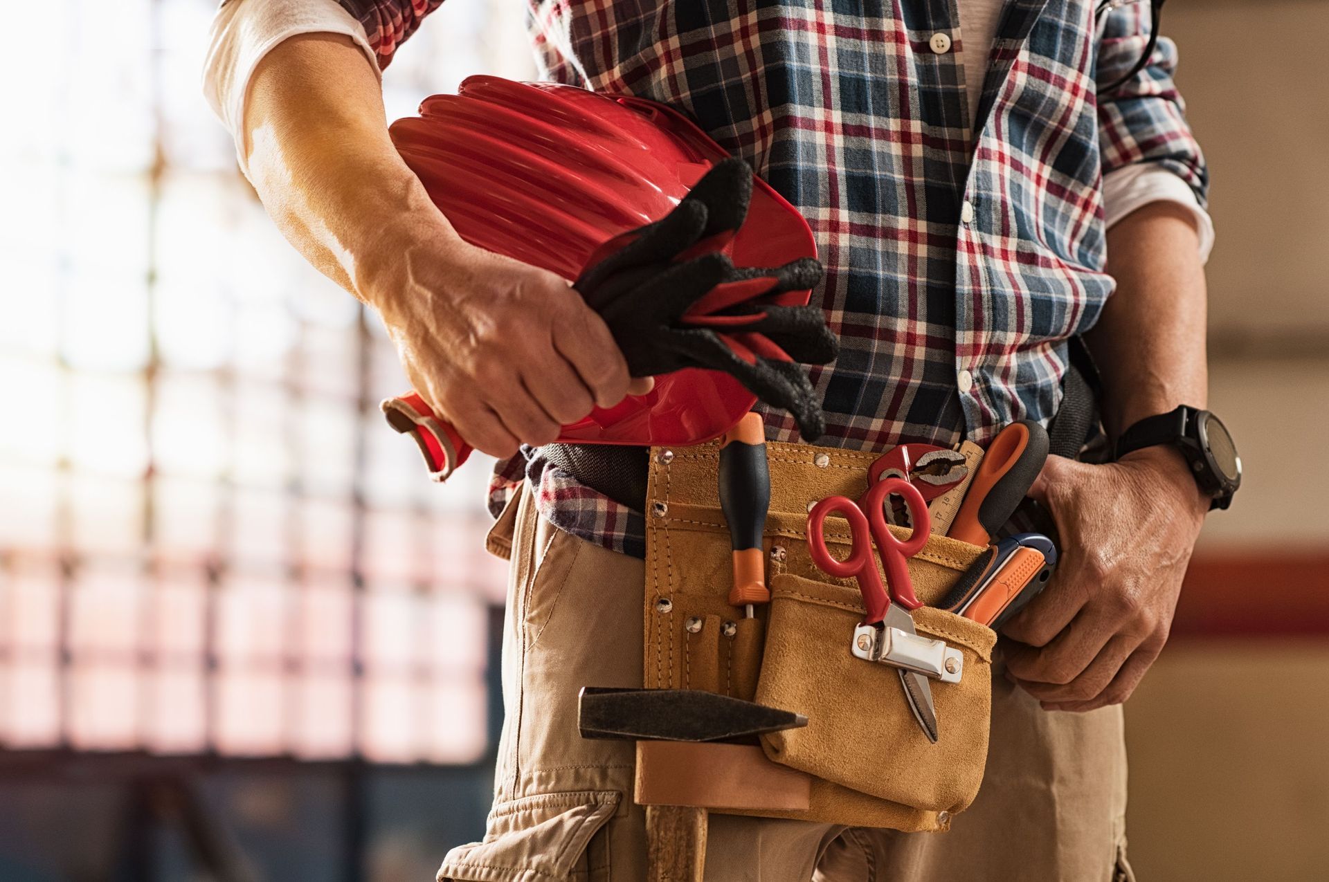 closeup bricklayer hands holding hardhat construction