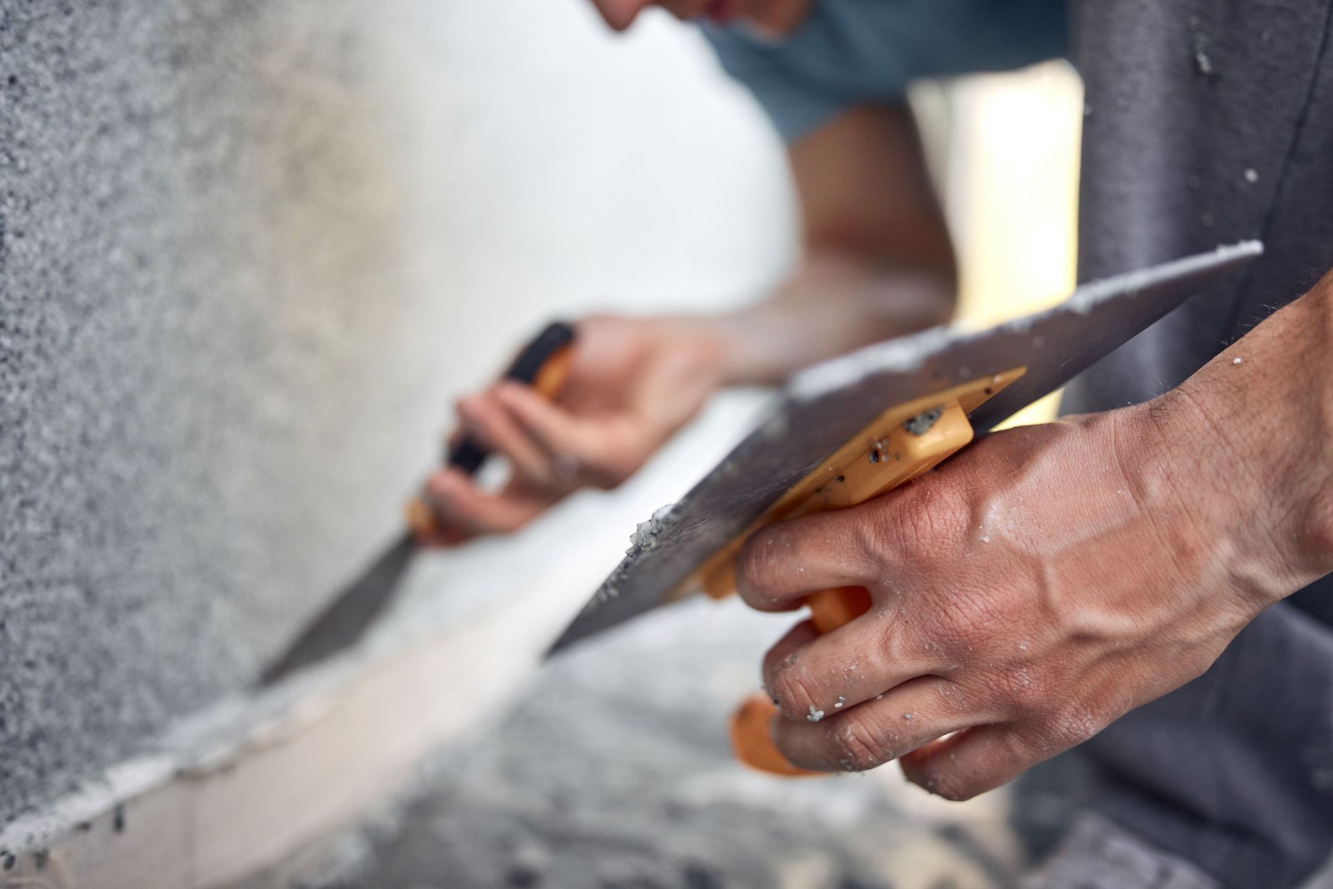 man working on house facade