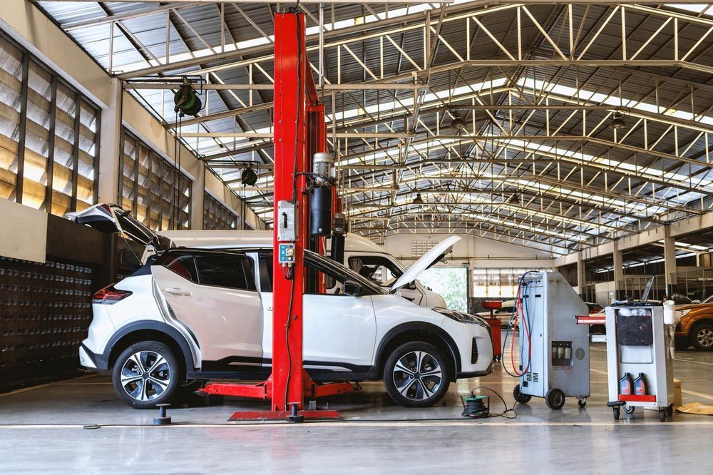 A Car Is Sitting On A Lift In A Garage — Auto Marvel In Mount Saint John, QLD