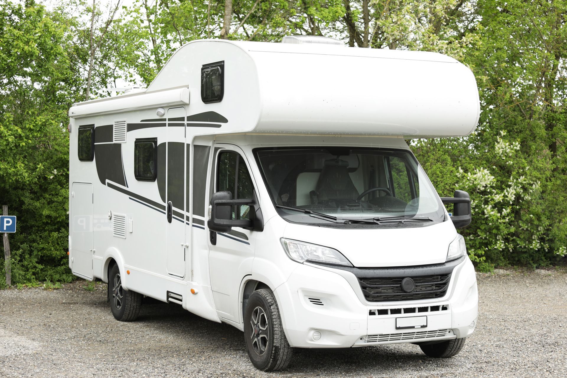 White Camper Van Parked on a Tree-lined Road — Auto Marvel in Townsville, QLD