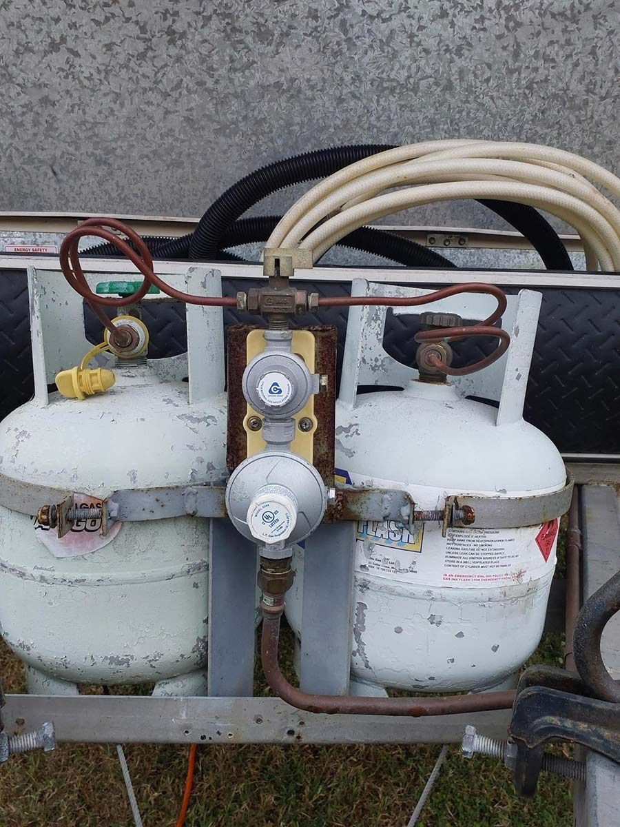 A Couple Of Propane Tanks Sitting On Top Of A Trailer — Auto Marvel In Mount Saint John, QLD