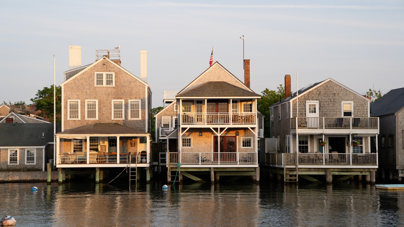 Wooden houses on stilts over water; a harbor scene.