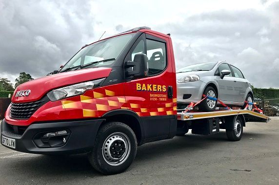 Bakers recovery truck loaded with car