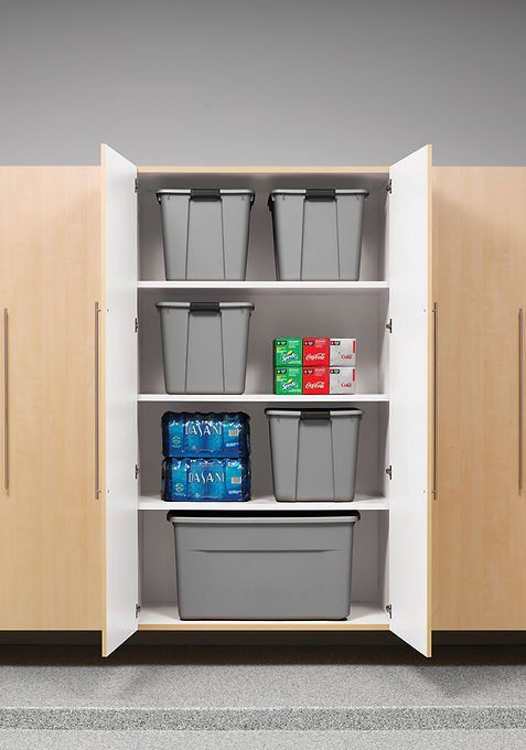 Storage cabinet with gray bins and shelf with beverages.
