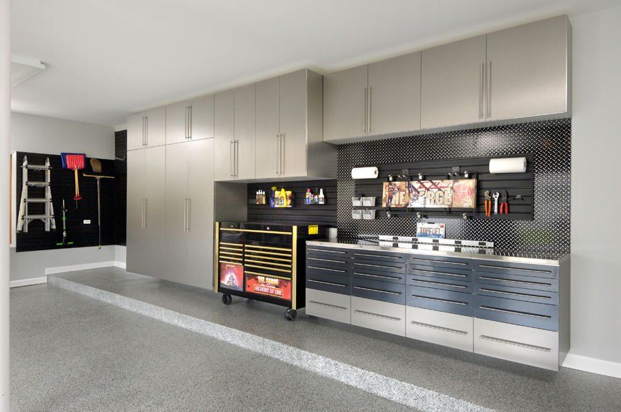 Modern garage with metallic cabinets and tool storage.