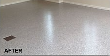 Finished epoxy-coated concrete floor. Gray speckled with subtle sheen. Corner of a room.