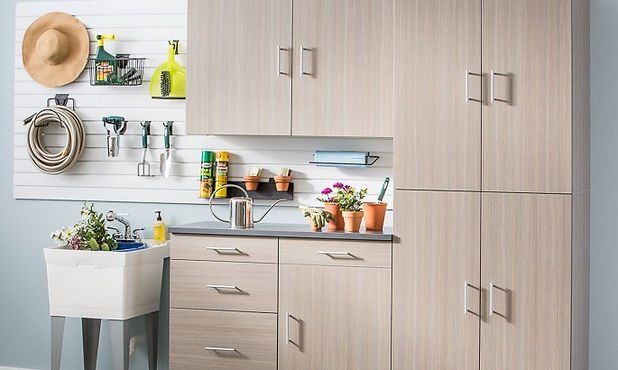 Garage storage with cabinets, sink, and pegboard for gardening tools and supplies.