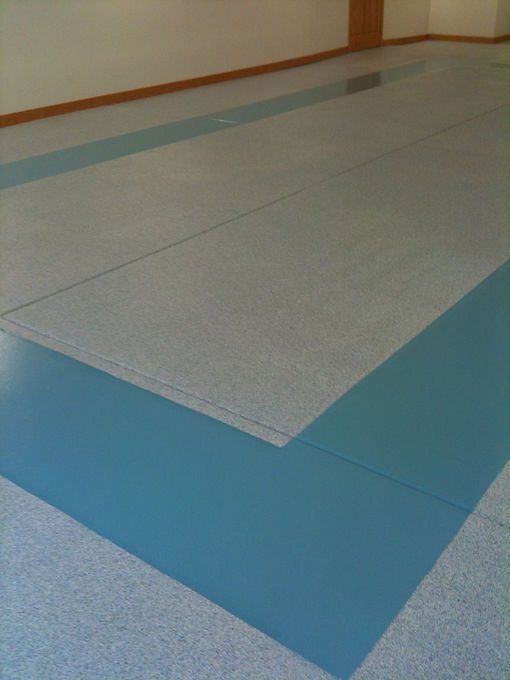 Blue and gray mat flooring in a room.