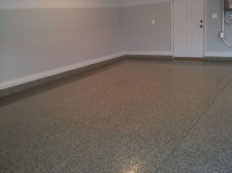Grey flecked epoxy garage floor. Grey walls, white trim and door.