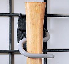 Garden tool handle held by a gray hook on a black wire grid.