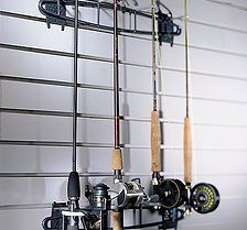 Fishing rods hanging on a wall-mounted rack.