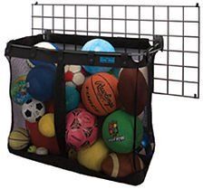 Black mesh ball storage basket hanging on a wire grid, filled with sports balls.
