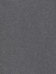 Dark gray, textured surface with tiny, light-colored specks.