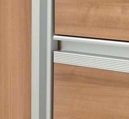 Wooden cabinet with silver drawer pulls and a vertical silver frame.