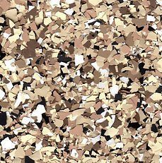 Close-up of tan and brown epoxy floor flakes, with small patches of black and white.