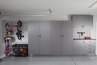 Garage with gray cabinets, storage, and bike rack.