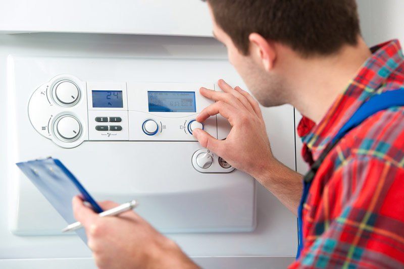 Plumber Servicing The Gas Boiler For Hot Water — Dempsey Plumbing in Long Jetty
