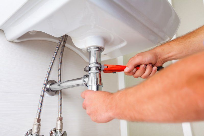 Plumber Holding A Wrench — Dempsey Plumbing in Narara