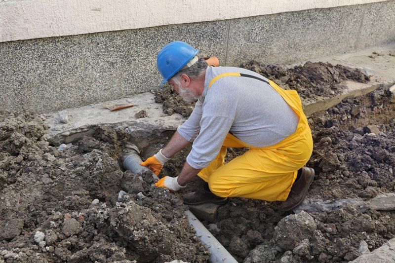 Plumber Fixing Sewerage Pipe — Dempsey Plumbing in Narara