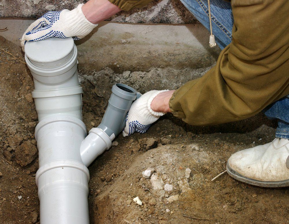 Plumber Assembling PVC Sewage Pipes — Dempsey Plumbing In Erina