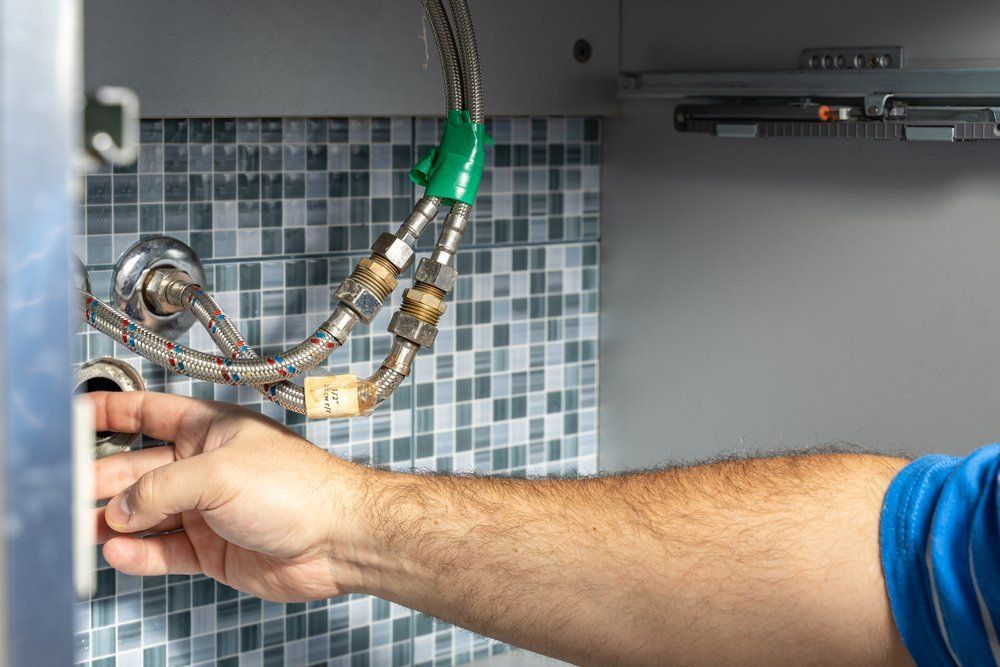 Plumber Removes The Blockage In The Pipes — Dempsey Plumbing in Wyong