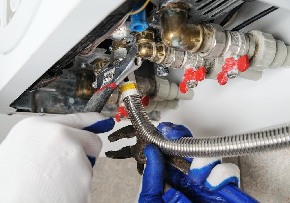 Plumber Attaches To Pipe Gas Boiler — Dempsey Plumbing In Erina