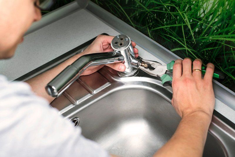Man Repair And Fixing Leaky Old Faucet — Dempsey Plumbing in Terrigal
