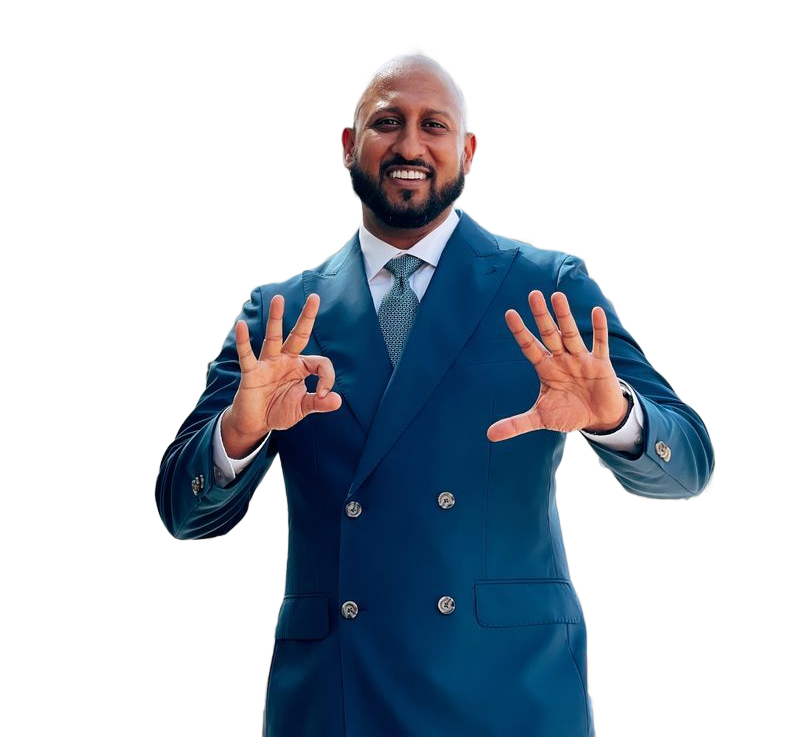 Man in blue suit, smiling, giving 