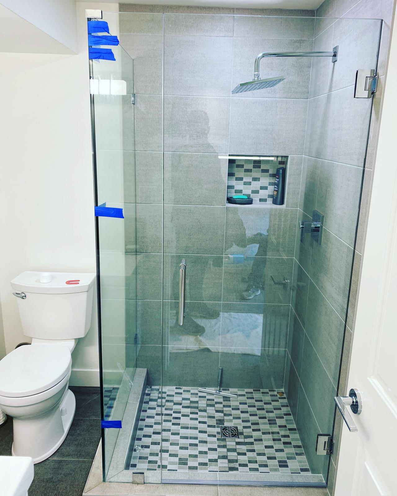 A bathroom with a toilet and a walk in shower