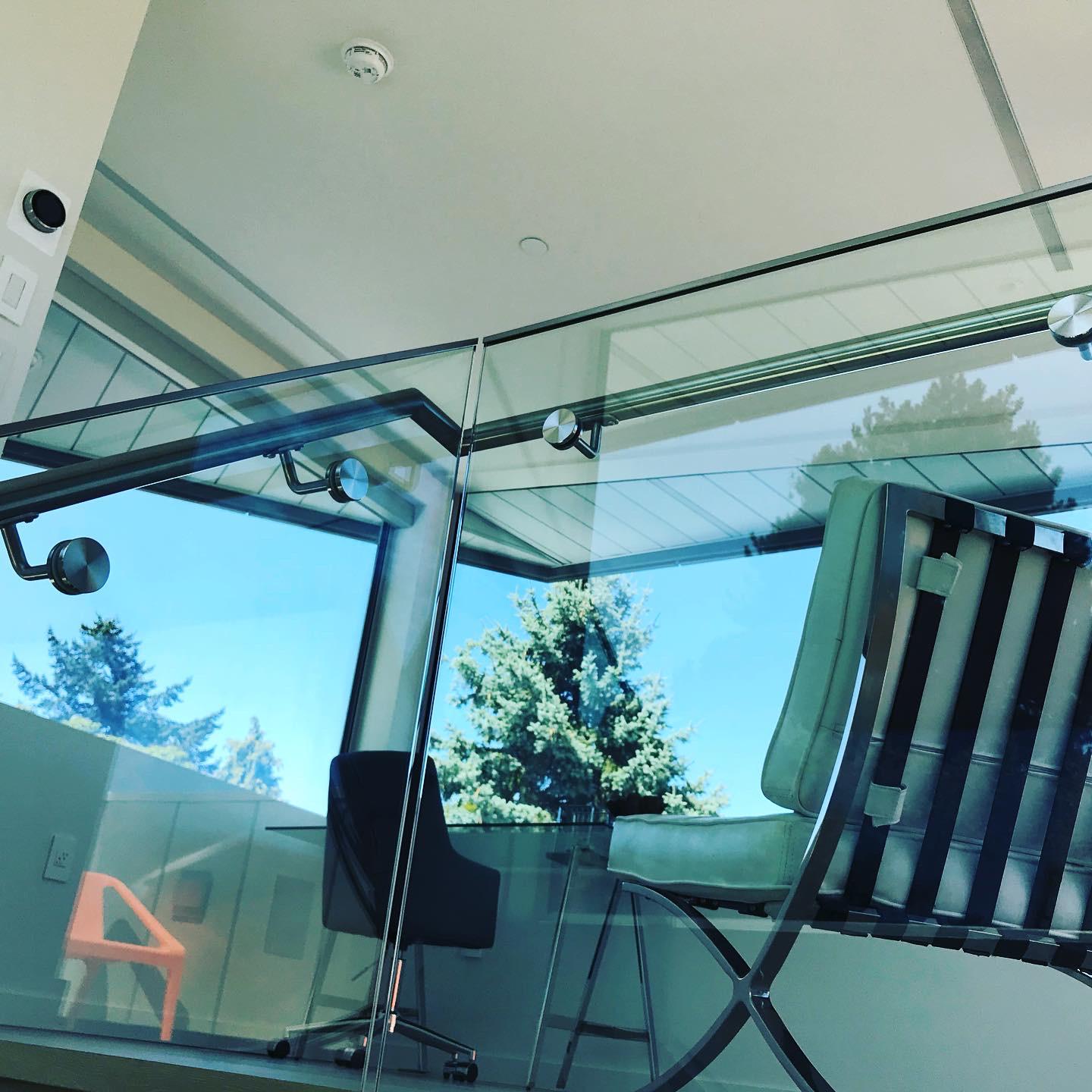 A reflection of a chair in a glass window