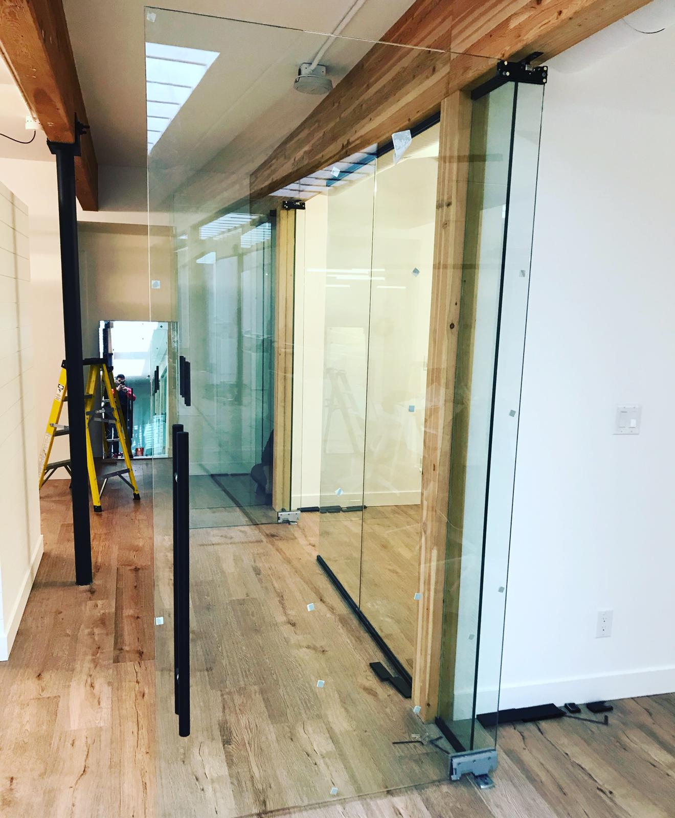 A hallway with sliding glass doors and a ladder.