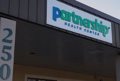 Sign for Partnership Health Center, with building number 