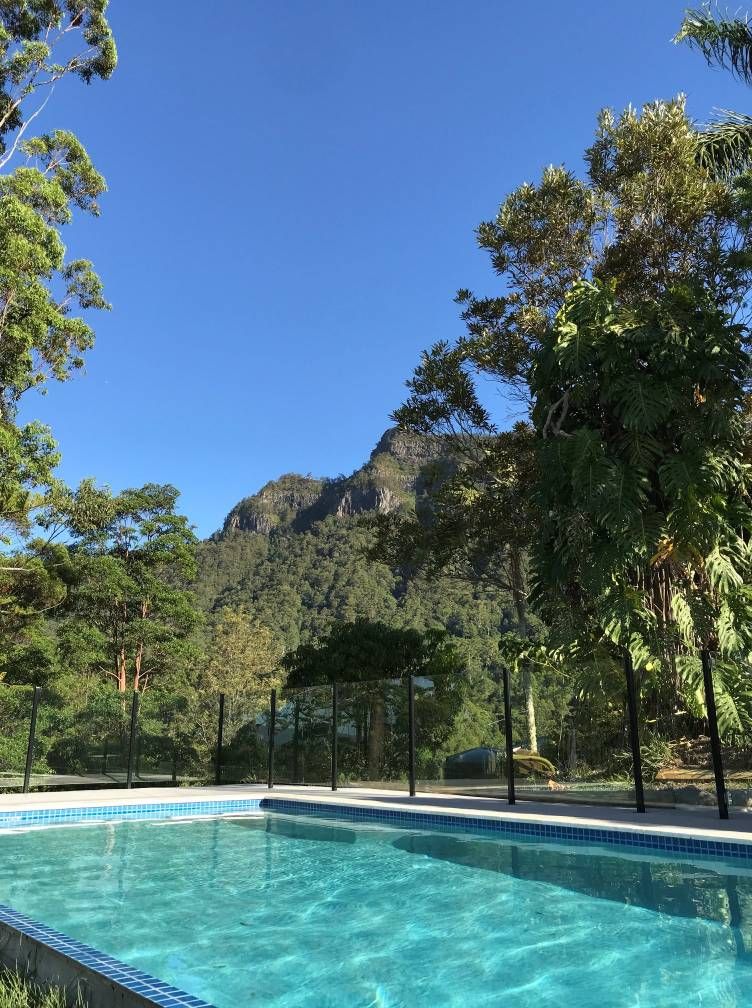 Swimming Pool Overlooking a Mountain Range Under a Clear Blue Sky — Banora Pools in Kingscliff, NSW