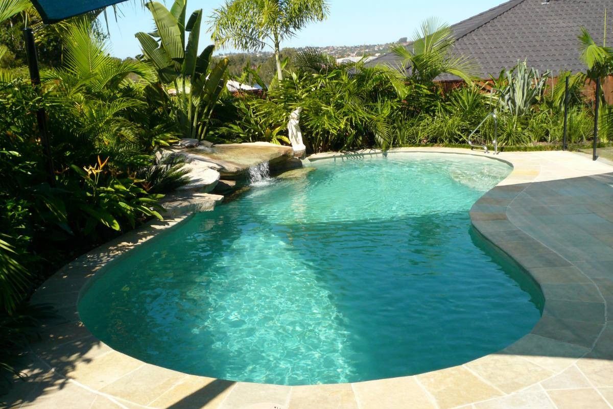 Swimming Pool Surrounded by Landscaping, With a Small Waterfall Feature — Banora Pools in Banora Point, NSW