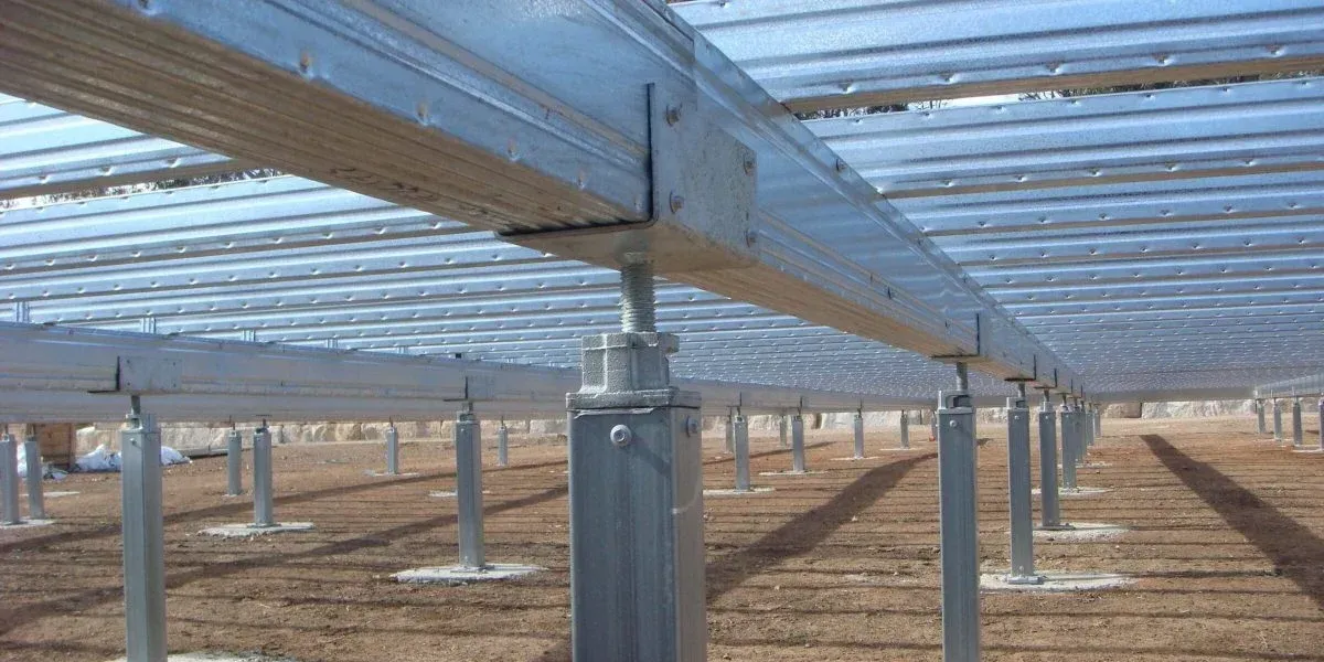Galvanized steel support posts and beams installed in an outdoor field, likely as the foundation for solar panel arrays.