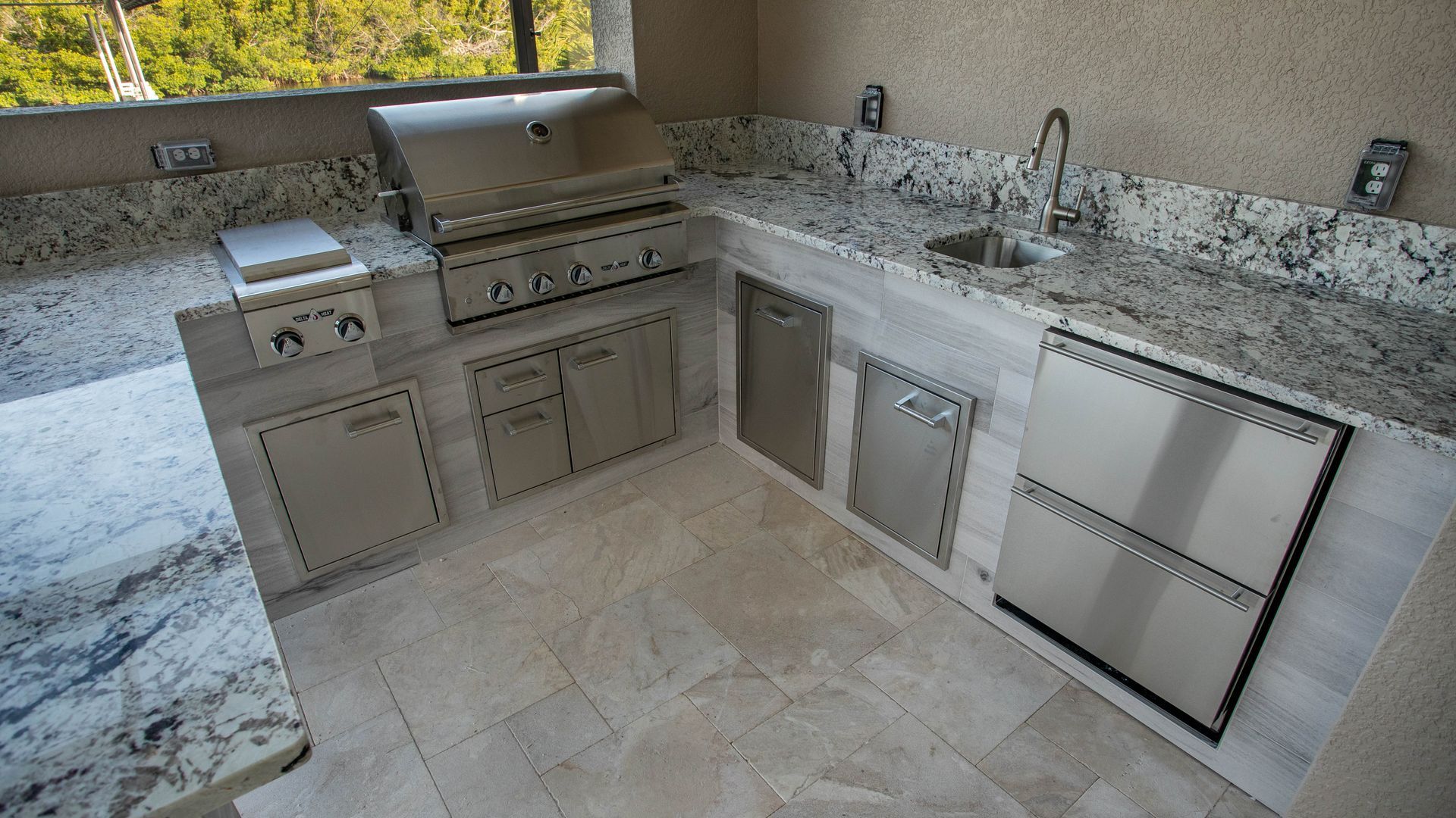 Wood look tile , U shape outdoor kitchen, , delta heat grill, Fridge, granite countertop , Fort Myers FL