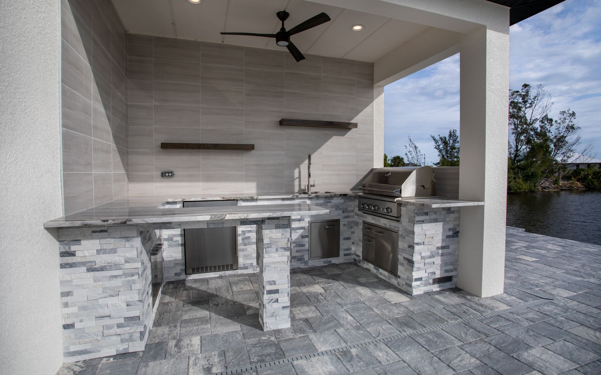 Stacked stone J shape outdoor kitchen, Bar seating, grey and white stone, granite countertop, Port Charlotte FL