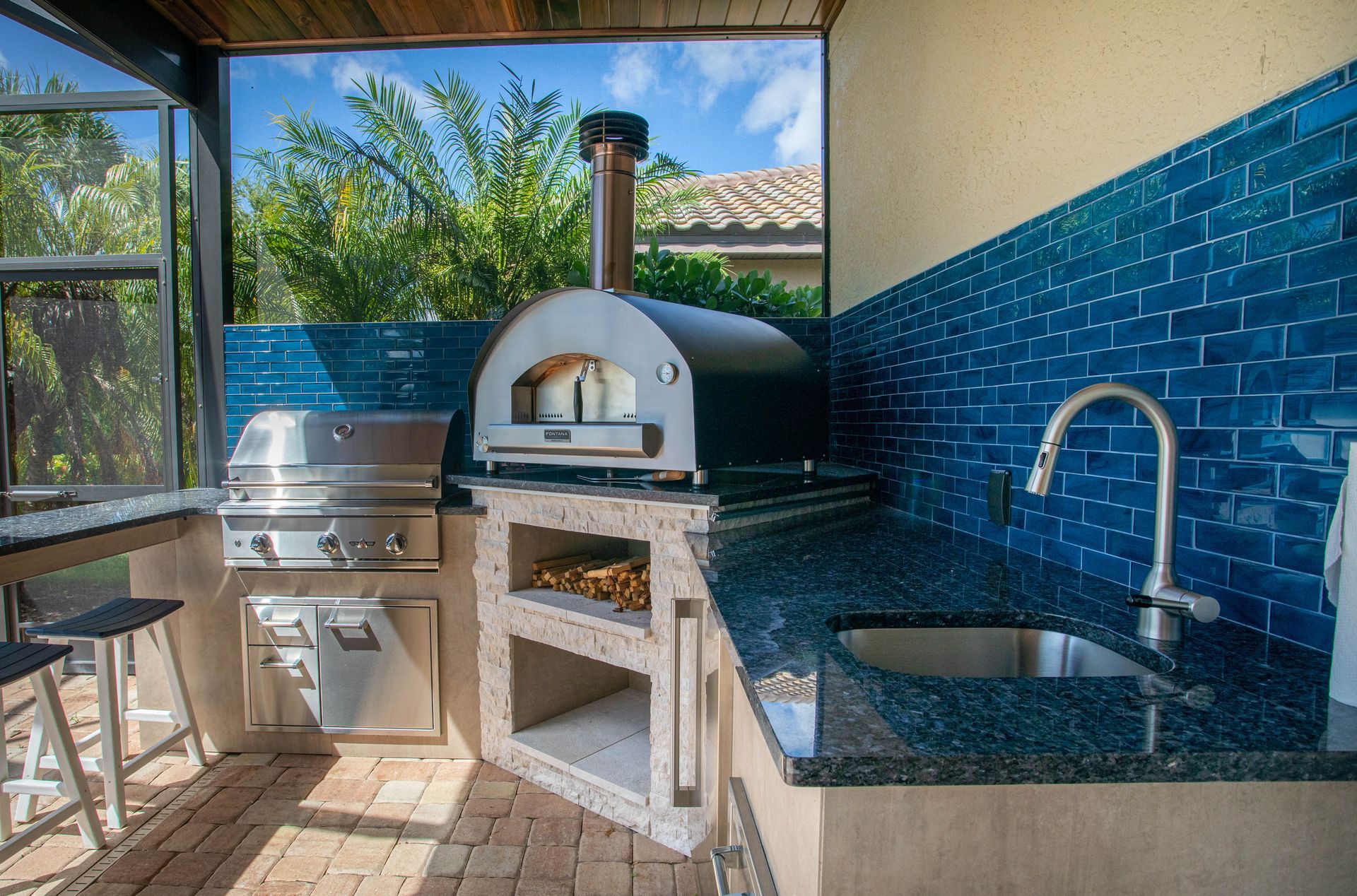 stacked stone outdoor kitchen, seating, pizza oven, delta heat grill, custom, granite countertop , sink, Naples FL
