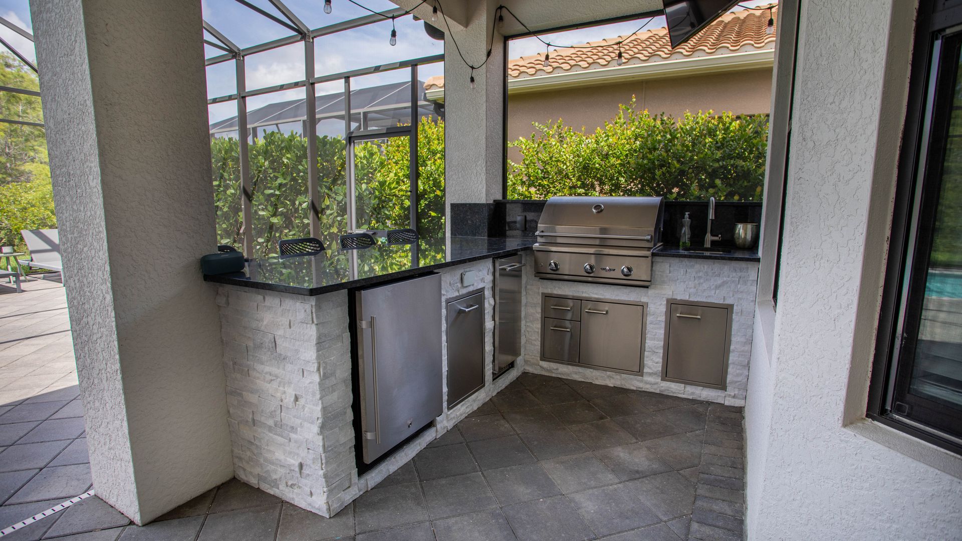 L Shape Outdoor Kitchen, Stacked stone, black Granite countertop , Delta Heat Grill, Delta Heat Inserts, Storage SWFL