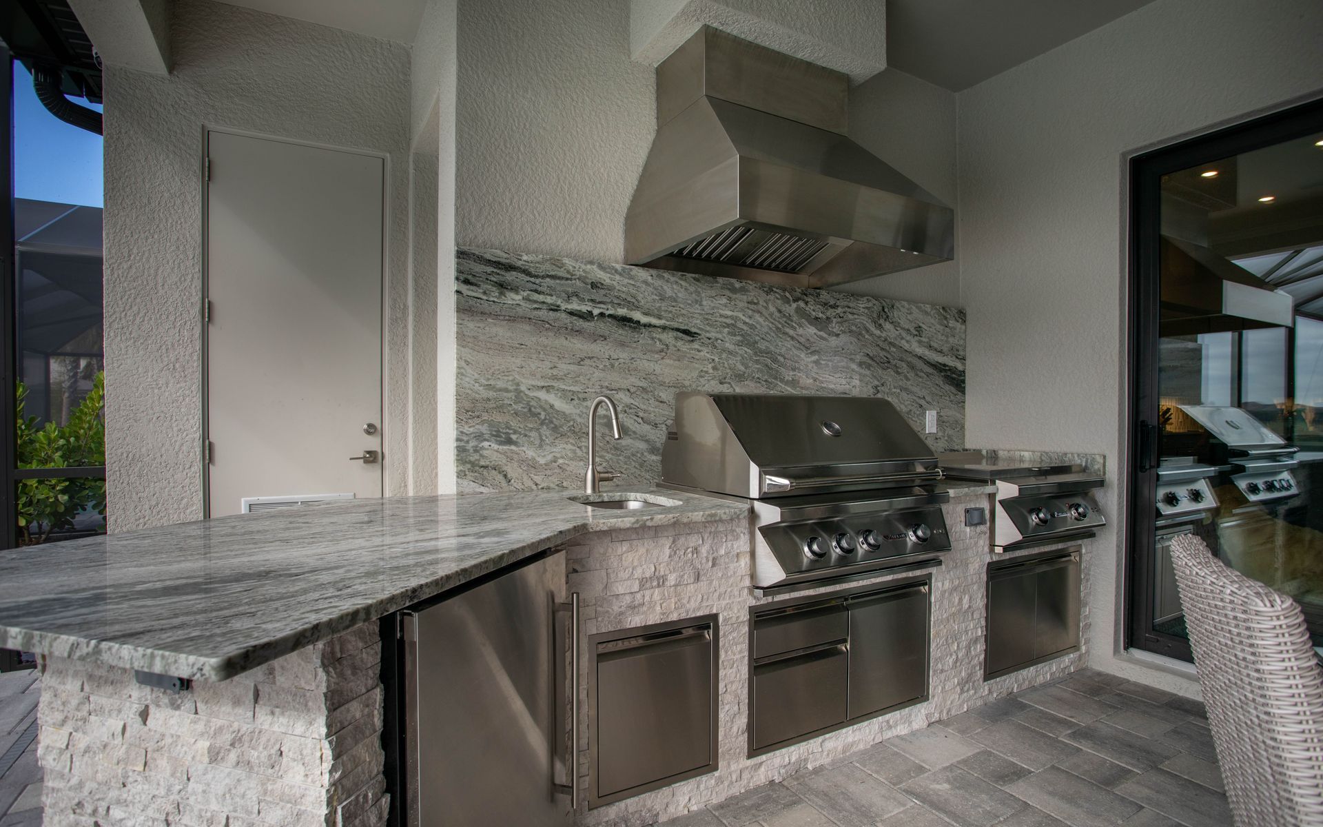 Shape Outdoor Kitchen, Granite countertop, Twin Eagles Grill, Delta Heat Inserts, Fridge, Storage Fort Myers FL